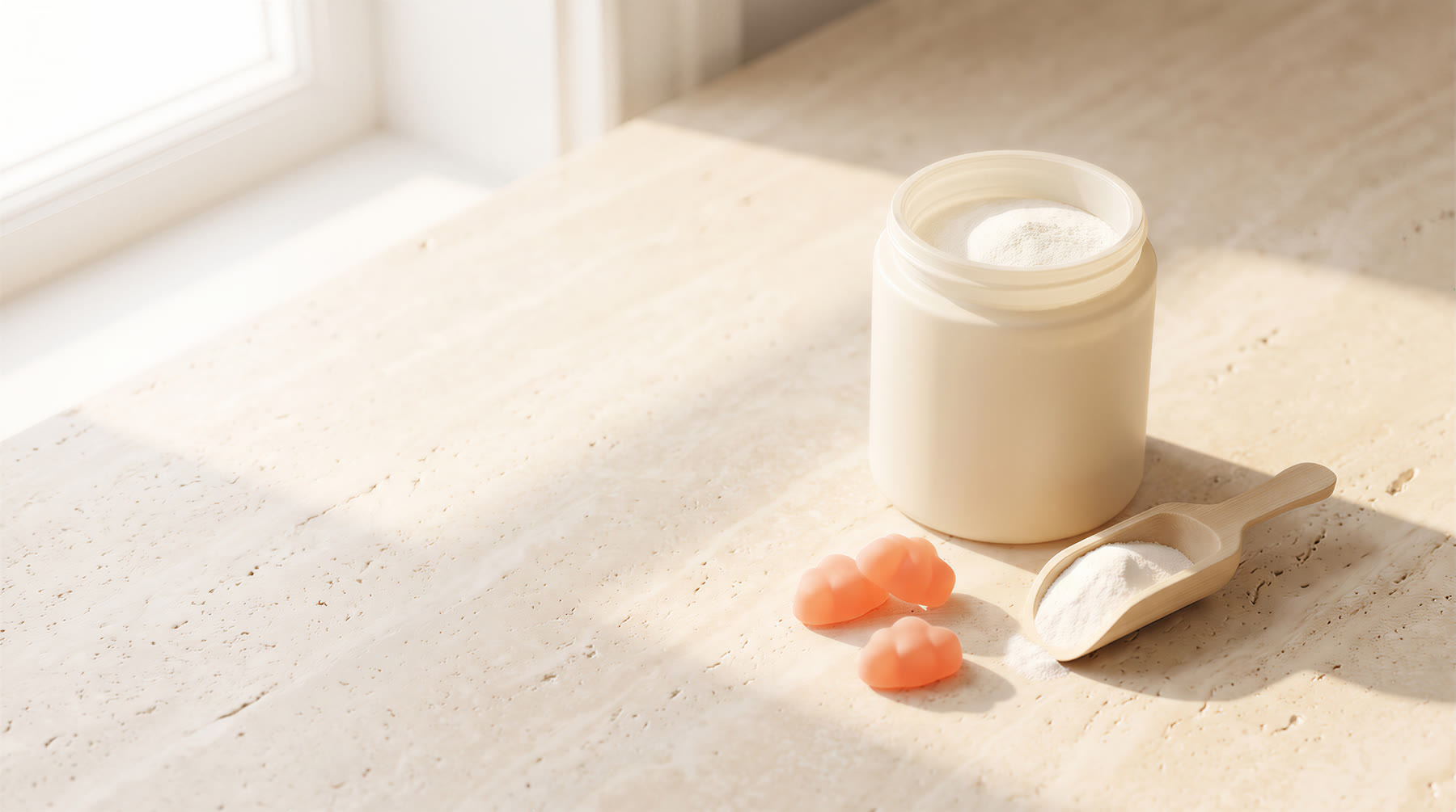 Creatine monohydrate jar with scoop and gummies on a stone counter